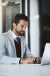 © Hira/peopleimages.com - Corporate man, smile and laptop in office for productivity, research and achievement of project goals. Business employee, happy and tech in workplace for positive email, investment and revenue report