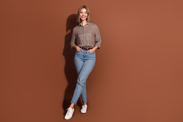 Sticker - Photo of lovely cute cheerful woman wear checkered stylish clothes isolated on brown color background