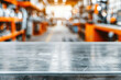 © tonstock - Blurred background of an industrial workshop with a focus on an empty metallic table in the foreground, perfect for product display or design mockups.