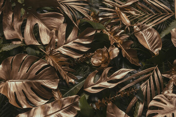 Wall Mural - creative nature background. gold and green tropical monstera and palm leaves. minimal summer abstrac