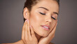© AK Coop/peopleimages.com - Salon, makeup and woman with hands on face in studio for cosmetics, wellness and satisfaction. Dermatology, spa aesthetic and person with eyes closed for beauty, salon and skincare on gray background