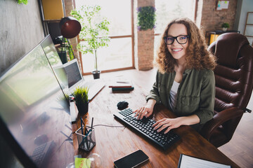 Wall Mural - Photo of nice successful woman software developer sitting armchair comfortable workspace workstation indoors