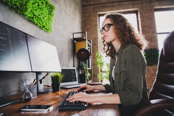 Photo of successful nice woman coder hacker sitting armchair comfortable workspace workstation indoors