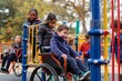 © BajimBa - Children with disabilities play together with other children, an inclusive playground