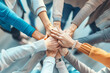 © vetre - Team Unity. Six individuals placing their hands together in a gesture of unity and teamwork.