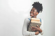 © RemsH - Portrait of happy young girl holding books over white background. Back to school