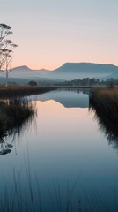 Wall Mural - A peaceful river with a mountain reflection at sunrise