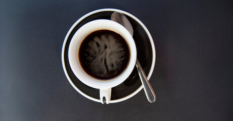 A cup of coffee on a black background. Espresso isolated on black.