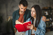© Miljan Živković - adult couple boyfriend and girlfriend read a book, learn together