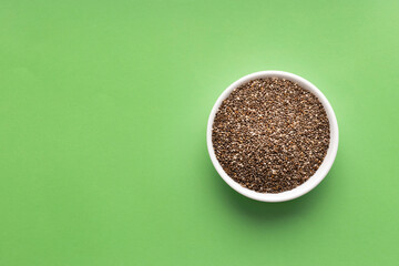 Wall Mural - Salvia Hispanica - Organic fresh chia seeds in bowl. green color background