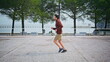 © stockbusters - Active man running seafront enjoying morning exercise. Motivated guy sprinting