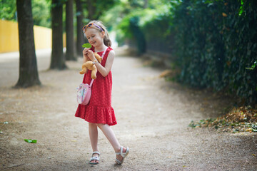 Wall Mural - Adorable preschooler girl walking in park in Paris, France