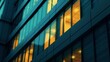 © panumas - A close-up view of an office building at night with lights on in some of the windows.