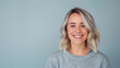 © Denis Yevtekhov - Portrait of a happy woman with stylish blonde hair and a bright smile on a simple gray background, joyful, fashion