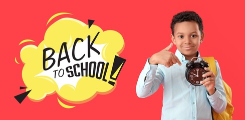 Poster - Little African-American boy with alarm clock and text BACK TO SCHOOL on red background