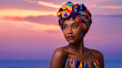 © Uncover4u - African American beautiful girl with Colorful Gele head wear at Sunset background