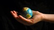 © sarana - Hand Holding a Globe: A hand holding a small globe, representing travel and global connections.
