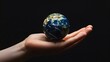 © sarana - Hand Holding a Globe: A hand holding a small globe, representing travel and global connections.
