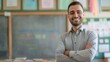 © gn8 - Smiling Middle Eastern Male School Teacher in Classroom, Education, Teaching, and Learning Environment Stock Photo