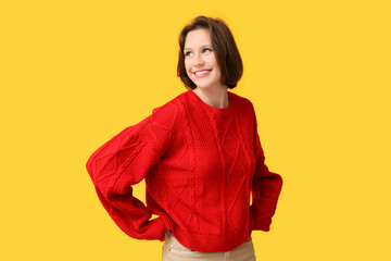 Sticker - Beautiful young woman in stylish red sweater on yellow background