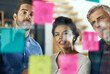 © Hira/peopleimages.com - People, group and sticky notes on glass for project ideas, planning and schedule management of startup. Staff, teamwork and paper for brainstorming, support goals or productivity solution in office