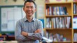 © gn8 - Warm Smiling Southeast Asian Male Teacher in Classroom, Educator Pride, Cultural Inclusivity