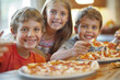 © lashkhidzetim - group of children are holding a pizza together. They are smiling and seem to be enjoying themselves