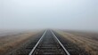 © Sukifli.D - An empty, straight railroad track extending into a foggy, infinite horizon