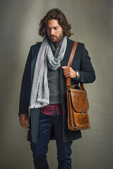 thinking, suit and man with leather bag in studio isolated on gray background. fashion, retro and se