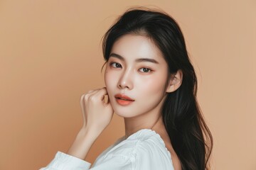 Wall Mural - Beautiful young Asian long hair woman in white clothes with Korean style makeup on her face and perfect skin on an isolated beige background. Facial care, cosmetology, plastic surgery - generative ai