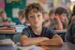© DesignStorez - Young Boy Sitting at Desk in Elementary School Classroom