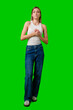 © fotofabrika - Young Woman Wearing White Tank Top and Blue Jeans Standing in Front of Green Screen
