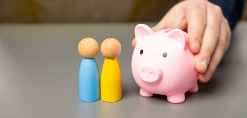 Wall Mural - A man holds a piggy bank in his hands near people of Ukrainian nationality. Budget of Ukraine and assistance to residents. Providing money, paying salaries and grants. Compensation payments.