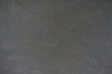 Surface of dusty and weathered dark grey painted wall