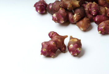 Poster - Close-up of raw red roots of Jerusalem artichoke on white floor, South Korea
