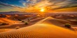 © Sirinporn - Vibrant orange hues illuminate a vast expanse of sandy dunes as the sun dips below the horizon, casting a serene and peaceful desert landscape.