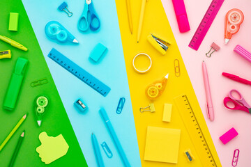 Wall Mural - Creative flat lay composition with colorful school supplies on background divided by colors. Back to school concept.