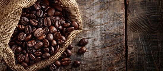 Poster - Coffee beans roasted and placed in a burlap sack on a wooden rustic backdrop with ample copy space image