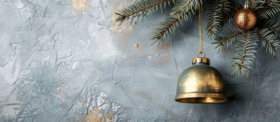 Poster - Christmas decoration featuring a golden bell hanging from a tree branch set against a gray New Year s backdrop with a copper copy space image