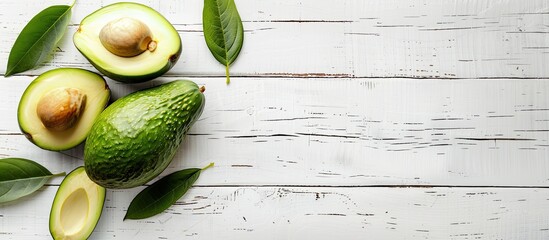 Sticker - Avocado placed on a white wooden table with a blank space for an image. Creative banner. Copyspace image