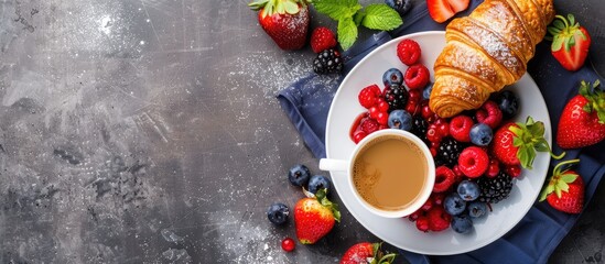 Wall Mural - Top view of a breakfast themed image featuring fresh berries a croissant and coffee designed with space for additional content