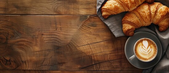 Poster - Croissant and coffee freshly served on a wooden backdrop with copy space image