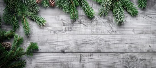 Poster - Top view of a Christmas themed gray wooden background adorned with a fir tree providing a designated area for your design or text in the copy space image