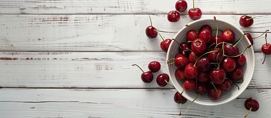 Sticker - A vibrant bowl of cherries set against a white wooden backdrop provides an appealing copy space image