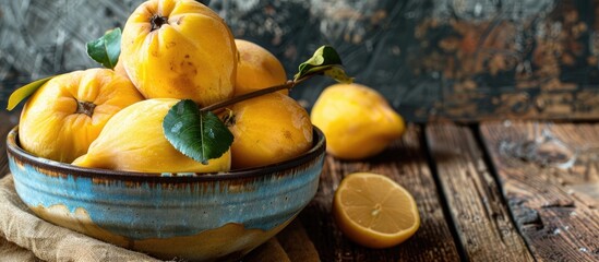 Poster - Close up of delicious ripe quinces in a bowl on a wooden table with copy space image available
