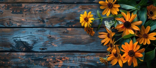 Poster - Arrangement of Rudbeckia and marigold heads on a wooden background creates a picturesque copy space image