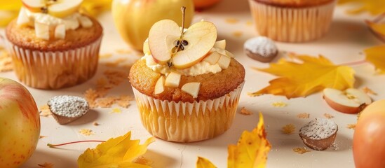 Poster - A broken homemade Apple cupcake with Apple filling on a light background with yellow leaves evokes the essence of fall baking and harvest in the copy space image