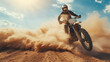 © Evgeniia - A motocross racer rides through the desert dunes. Motocross sport. Sandstorm. Rally racing. Background for design. A motorcyclist rides a motorcycle on the sand. Dynamic image.