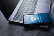 © Elena Uve - Smartphone laying on laptop with medical app on screen. Online video consultation. Telehealth Services.