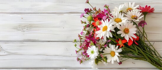 Poster - Top view of a bouquet of fresh flowers Gypsy bells on a white wooden background with copy space image